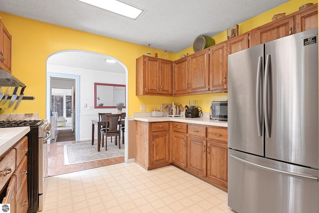9916 S M-37, Buckley, MI 49620 - kitchen featuring light countertops, stainless steel appliances, and brown cabinets