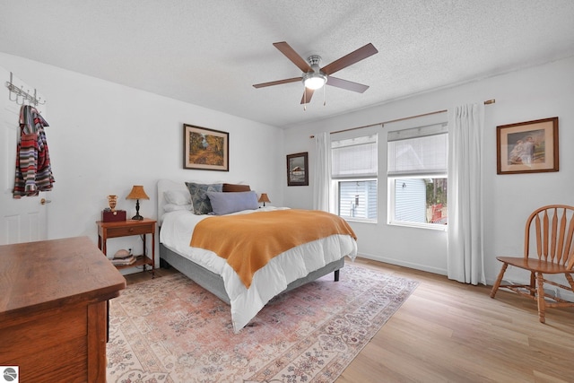 9916 S M-37, Buckley, MI 49620 - bedroom featuring baseboards, a textured ceiling, ceiling fan, and light wood-style floors