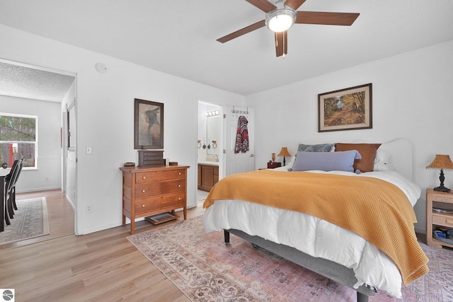 9916 S M-37, Buckley, MI 49620 - bedroom with connected bathroom, baseboards, ceiling fan, and light wood-type flooring