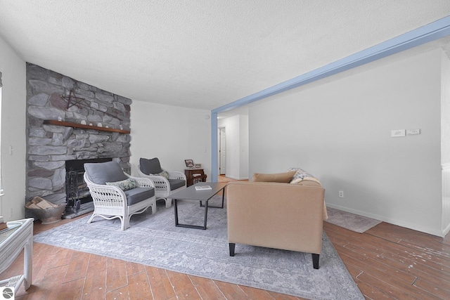 9916 S M-37, Buckley, MI 49620 - living room featuring a textured ceiling, a fireplace, and hardwood / wood-style flooring