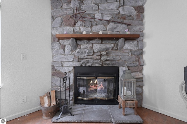 9916 S M-37, Buckley, MI 49620 - details featuring baseboards, wood finished floors, and a fireplace
