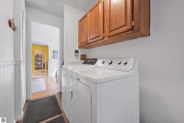 9916 S M-37, Buckley, MI 49620 - laundry area with cabinet space, arched walkways, washing machine and dryer, and light wood-style flooring