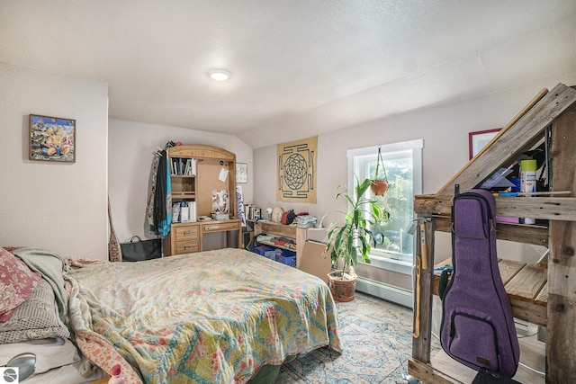 bedroom with baseboard heating and lofted ceiling