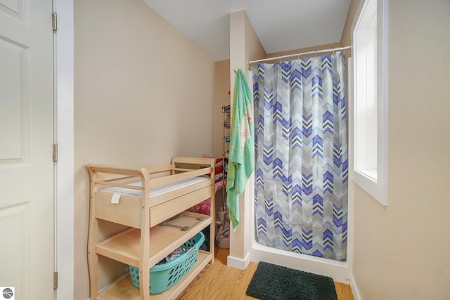 bedroom featuring baseboards and wood finished floors