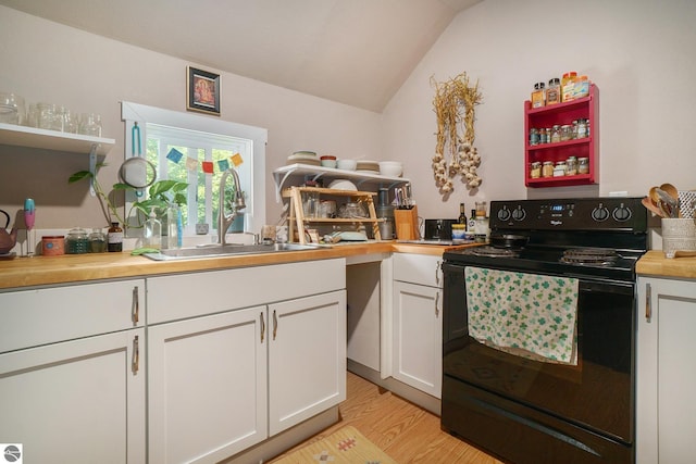 kitchen with electric range, a sink, white cabinetry, light wood-type flooring, and vaulted ceiling