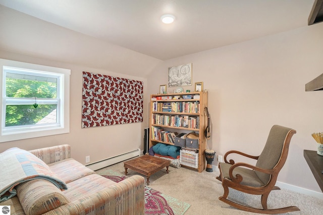 living area featuring baseboards, baseboard heating, and carpet flooring