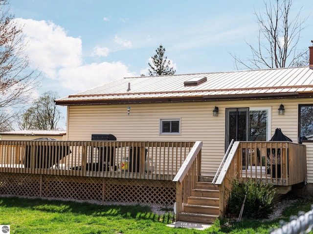 431 E Bittner Ave, Reed City, MI 49618 - back of property with a wooden deck and metal roof