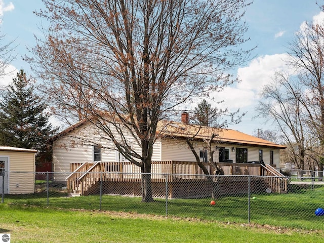 431 E Bittner Ave, Reed City, MI 49618 - rear view of property with a yard, a wooden deck, a fenced backyard, and a chimney
