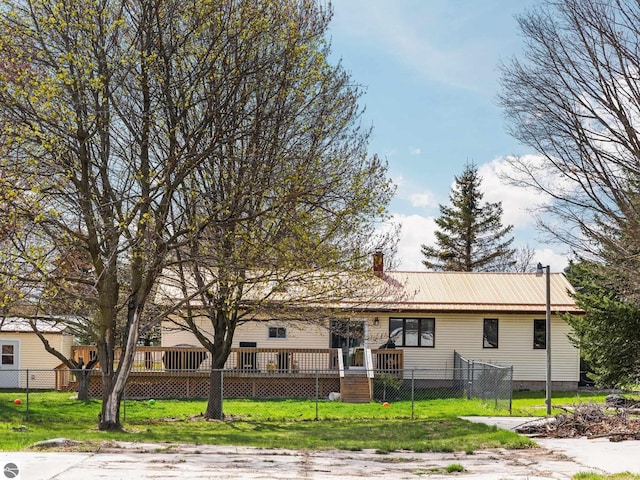 431 E Bittner Ave, Reed City, MI 49618 - ranch-style home featuring a chimney, a fenced front yard, a front yard, and metal roof