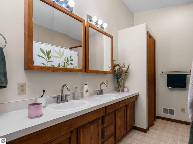 431 E Bittner Ave, Reed City, MI 49618 - full bathroom featuring visible vents, a sink, tile patterned floors, and double vanity