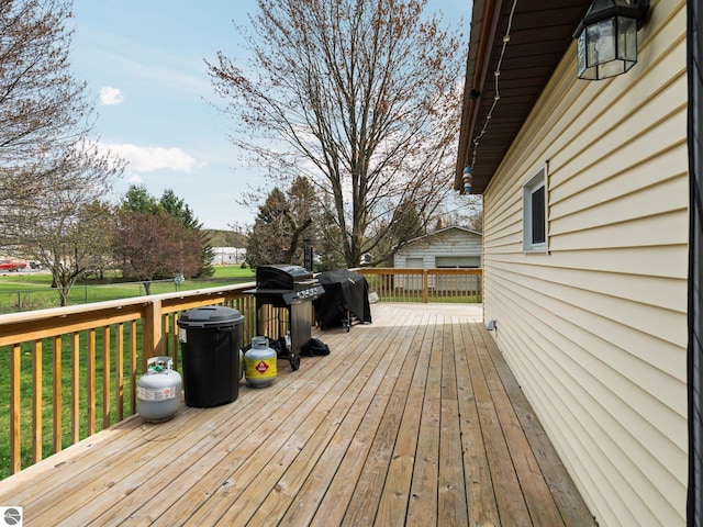 431 E Bittner Ave, Reed City, MI 49618 - wooden deck with a lawn, fence, and area for grilling