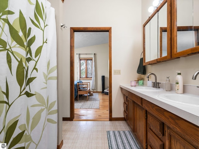 431 E Bittner Ave, Reed City, MI 49618 - full bathroom featuring double vanity, a sink, baseboards, and tile patterned floors
