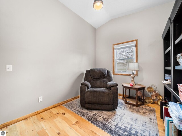 431 E Bittner Ave, Reed City, MI 49618 - sitting room with baseboards, vaulted ceiling, and wood finished floors