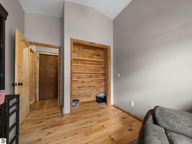 431 E Bittner Ave, Reed City, MI 49618 - bedroom featuring light wood-type flooring, baseboards, and vaulted ceiling
