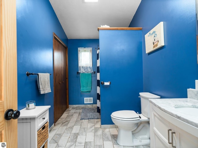 431 E Bittner Ave, Reed City, MI 49618 - bathroom with toilet, visible vents, and vanity