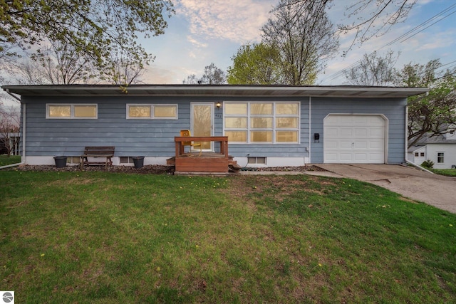 422 W Center, Alma, MI 48801 - view of front of house with concrete driveway, a front yard, and a garage