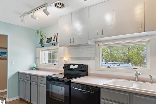 422 W Center, Alma, MI 48801 - kitchen with visible vents, gray cabinets, rail lighting, a sink, and black appliances