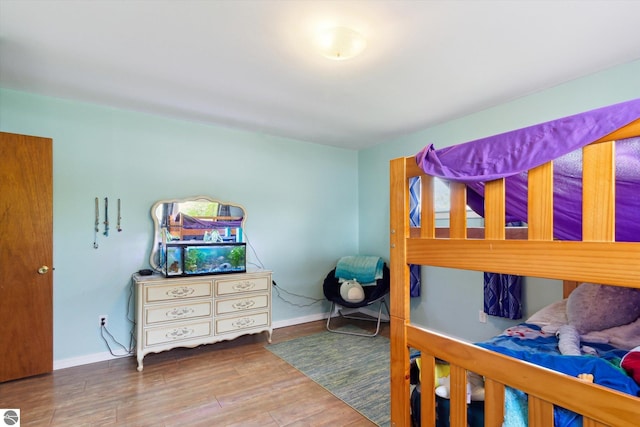 422 W Center, Alma, MI 48801 - bedroom with baseboards and wood finished floors