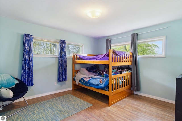 422 W Center, Alma, MI 48801 - bedroom with baseboards and wood finished floors