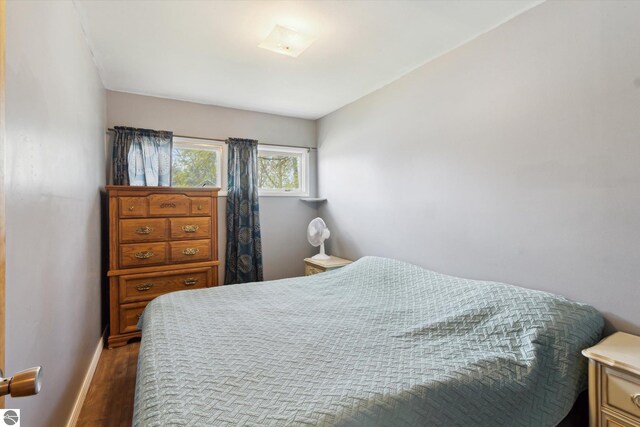 422 W Center, Alma, MI 48801 - bedroom with baseboards and wood finished floors