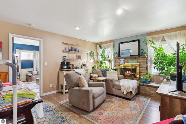 422 W Center, Alma, MI 48801 - living room featuring baseboards, a fireplace, and wood finished floors