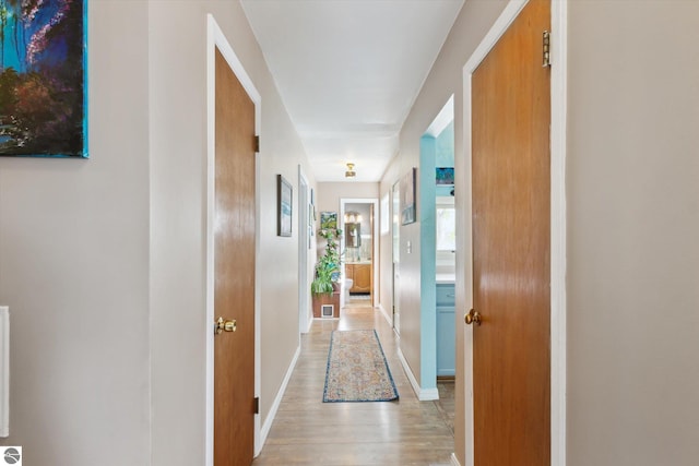422 W Center, Alma, MI 48801 - corridor featuring light wood-style floors and baseboards