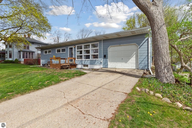 422 W Center, Alma, MI 48801 - ranch-style house featuring a garage, concrete driveway, and a front yard
