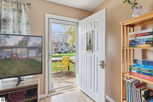 422 W Center, Alma, MI 48801 - doorway to outside featuring baseboards