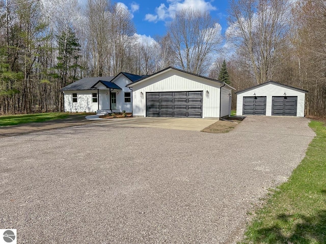 ranch-style home featuring a detached garage