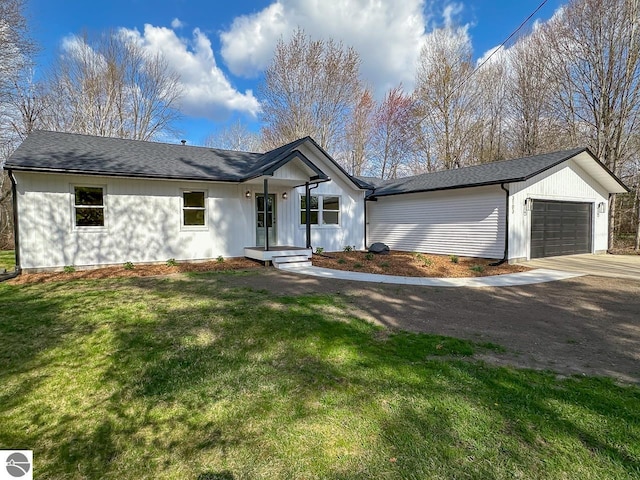 ranch-style house featuring a garage, driveway, and a front yard