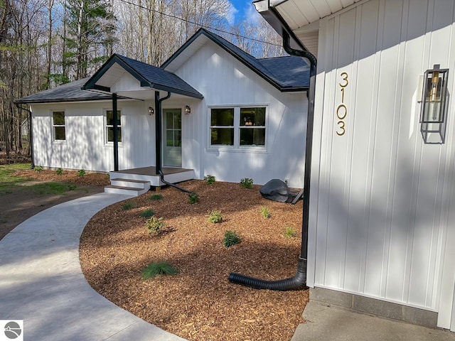 exterior space featuring a shingled roof