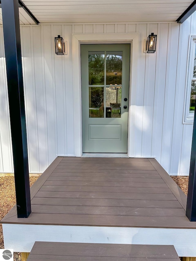 entrance to property featuring a porch and board and batten siding