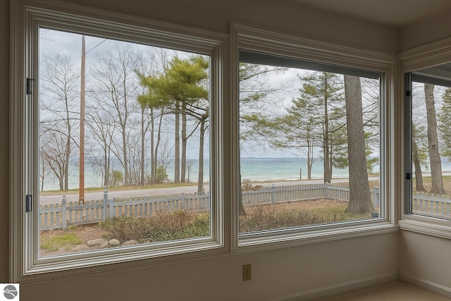interior details featuring baseboards and a water view