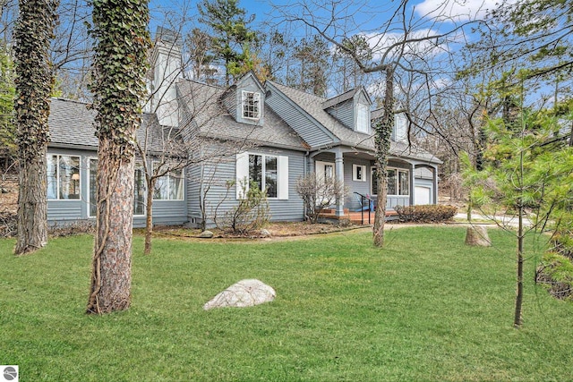 cape cod home with a garage, a front yard, and a shingled roof