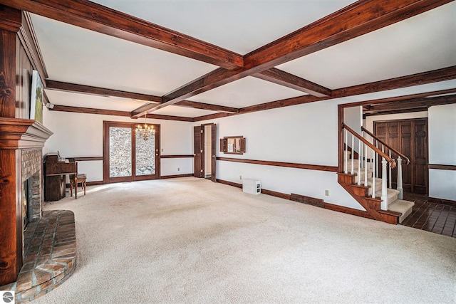 unfurnished living room featuring carpet flooring, baseboards, a chandelier, and beam ceiling