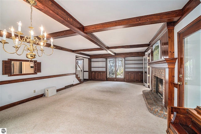 unfurnished living room with an inviting chandelier, light carpet, a fireplace, stairs, and beamed ceiling