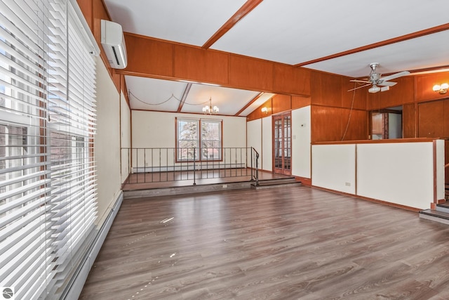 unfurnished living room with a wall mounted air conditioner, ceiling fan with notable chandelier, wood finished floors, vaulted ceiling, and a baseboard heating unit