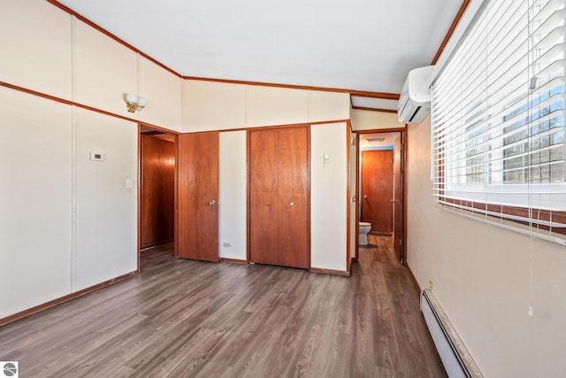 unfurnished bedroom with a wall unit AC, wood finished floors, baseboards, high vaulted ceiling, and a baseboard heating unit