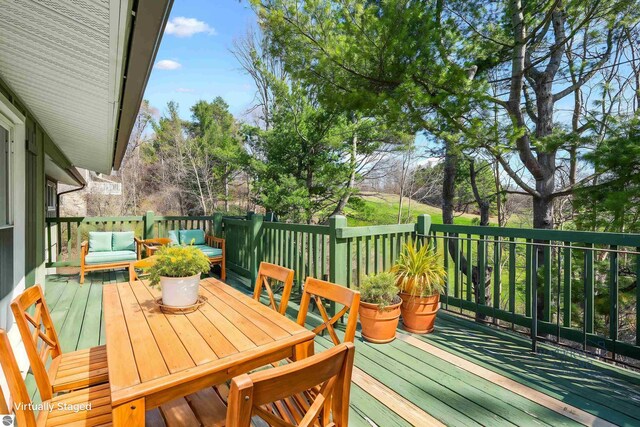 wooden deck with an outdoor living space