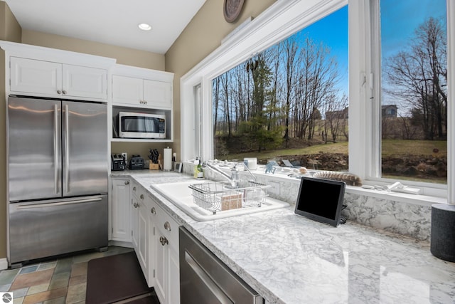 kitchen with recessed lighting, white cabinets, and stainless steel appliances
