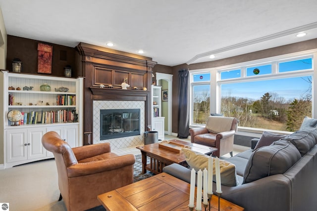living area with baseboards, recessed lighting, and a tile fireplace