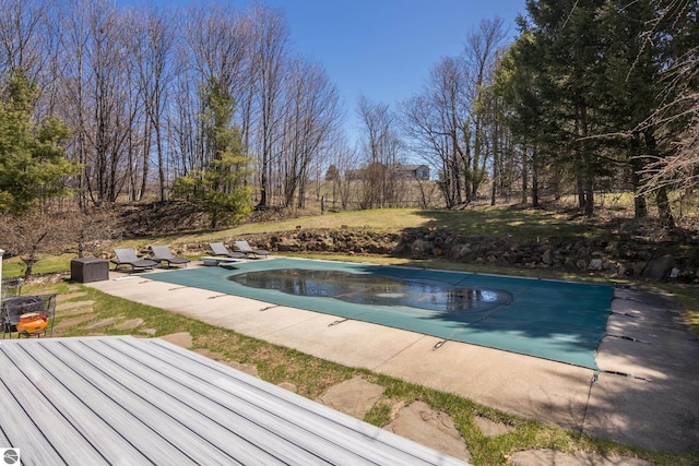 view of swimming pool featuring a patio and a covered pool