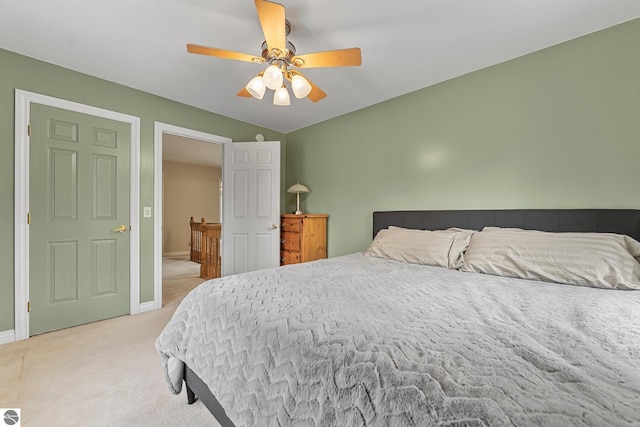 bedroom with baseboards, ceiling fan, lofted ceiling, and light colored carpet