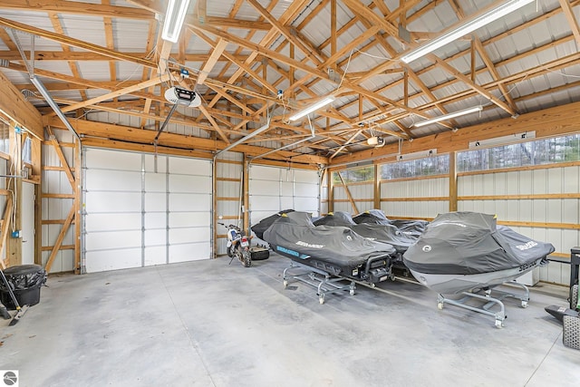 garage with a garage door opener and metal wall