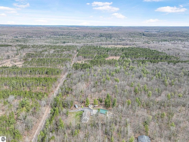 birds eye view of property with a wooded view