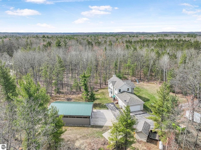 drone / aerial view featuring a forest view