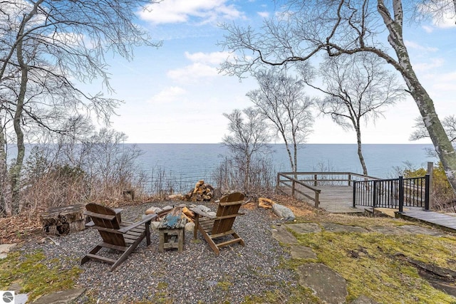 view of yard with a water view and an outdoor fire pit
