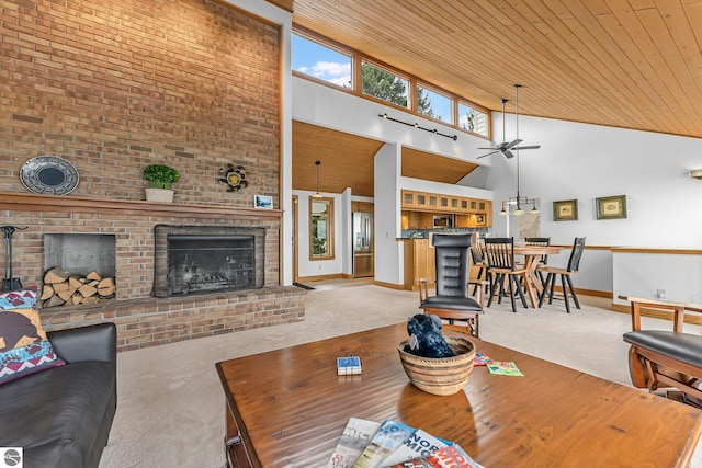 carpeted living area featuring a ceiling fan, a high ceiling, wood ceiling, and a fireplace