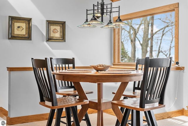 dining room with baseboards and an inviting chandelier
