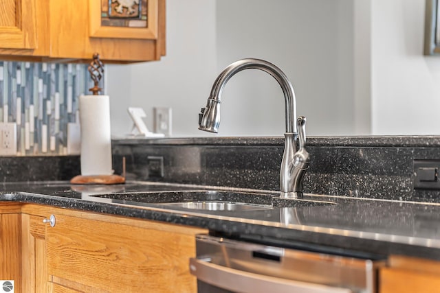 room details featuring a sink, glass insert cabinets, brown cabinets, and dishwasher
